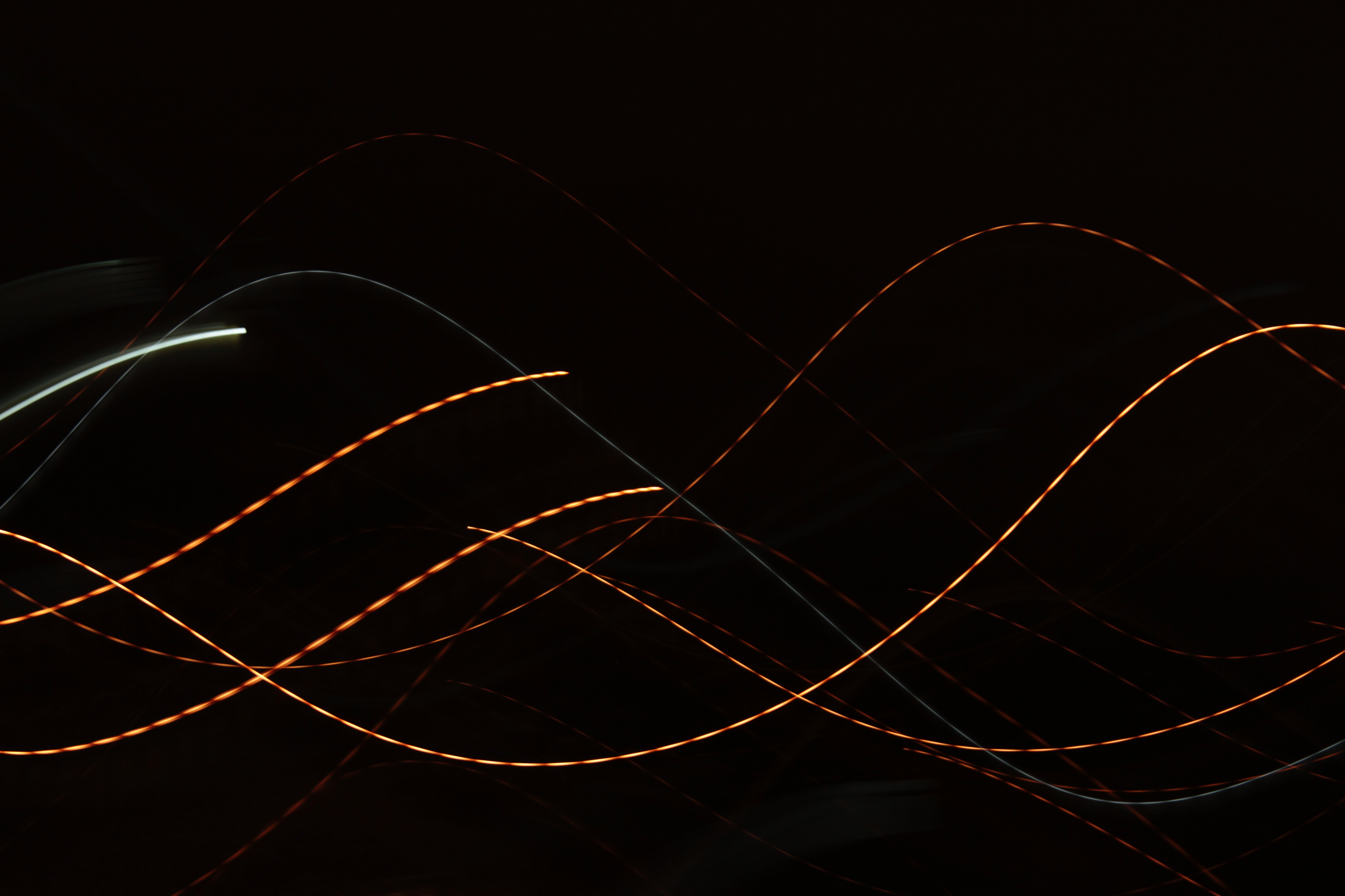 Colorful sine waves on a black background.